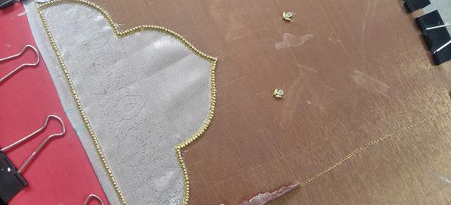 Blouse pattern being cut by hand